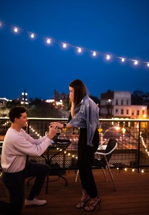 Evening rooftop scene with string lights creating romantic ambiance against deep blue sky.