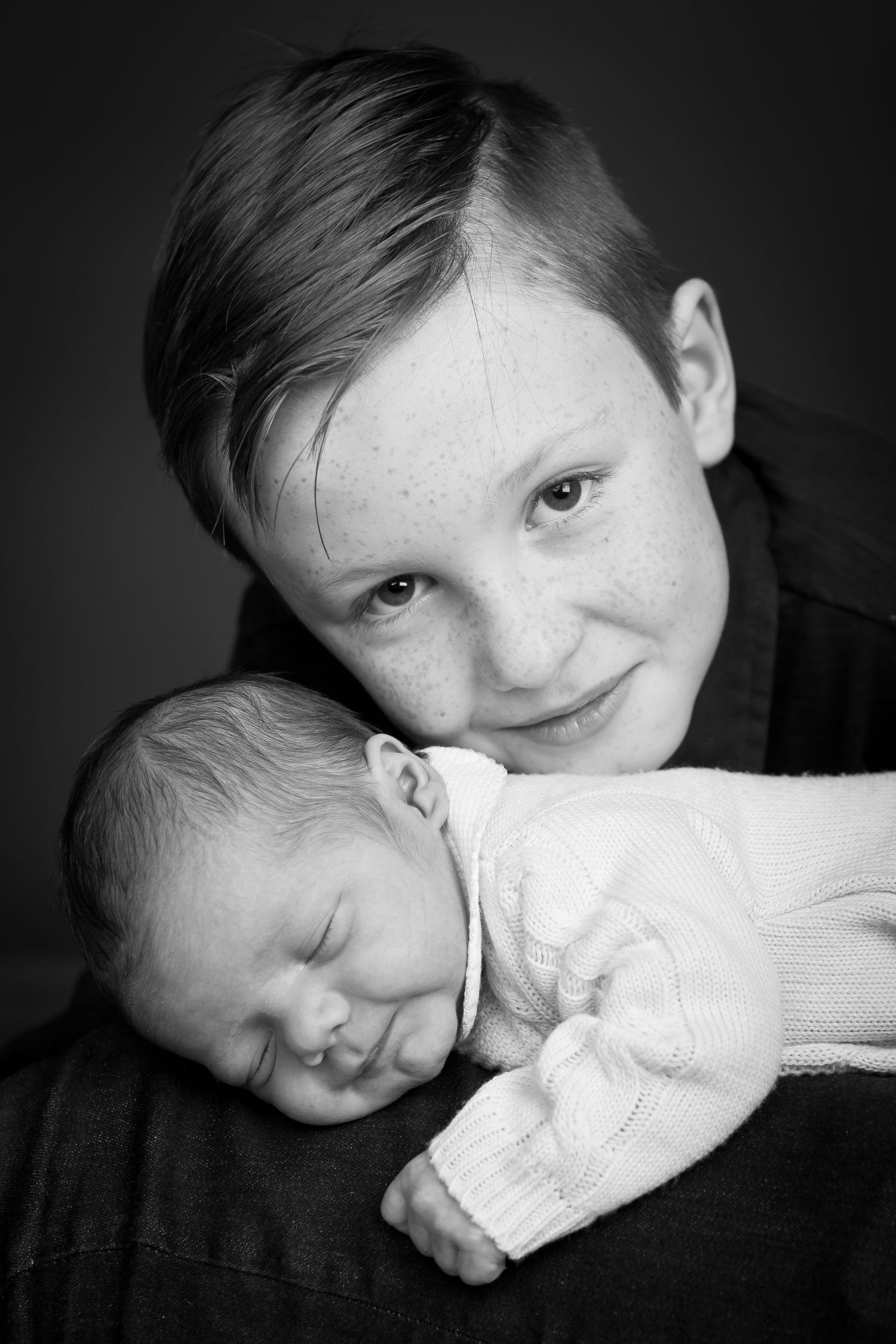 Baby boy on daddy's knees and his oder brother