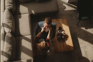 Aerial view of wedding preparations in a modern living room with natural lighting.