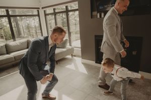 Emotional family embrace during wedding day preparations in modern venue.