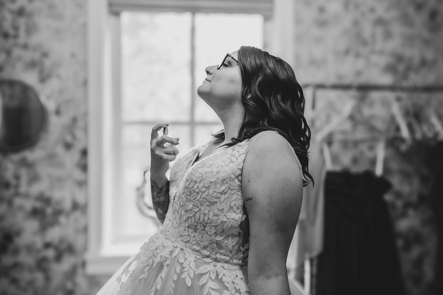 A candid black and white moment captured during wedding preparations.