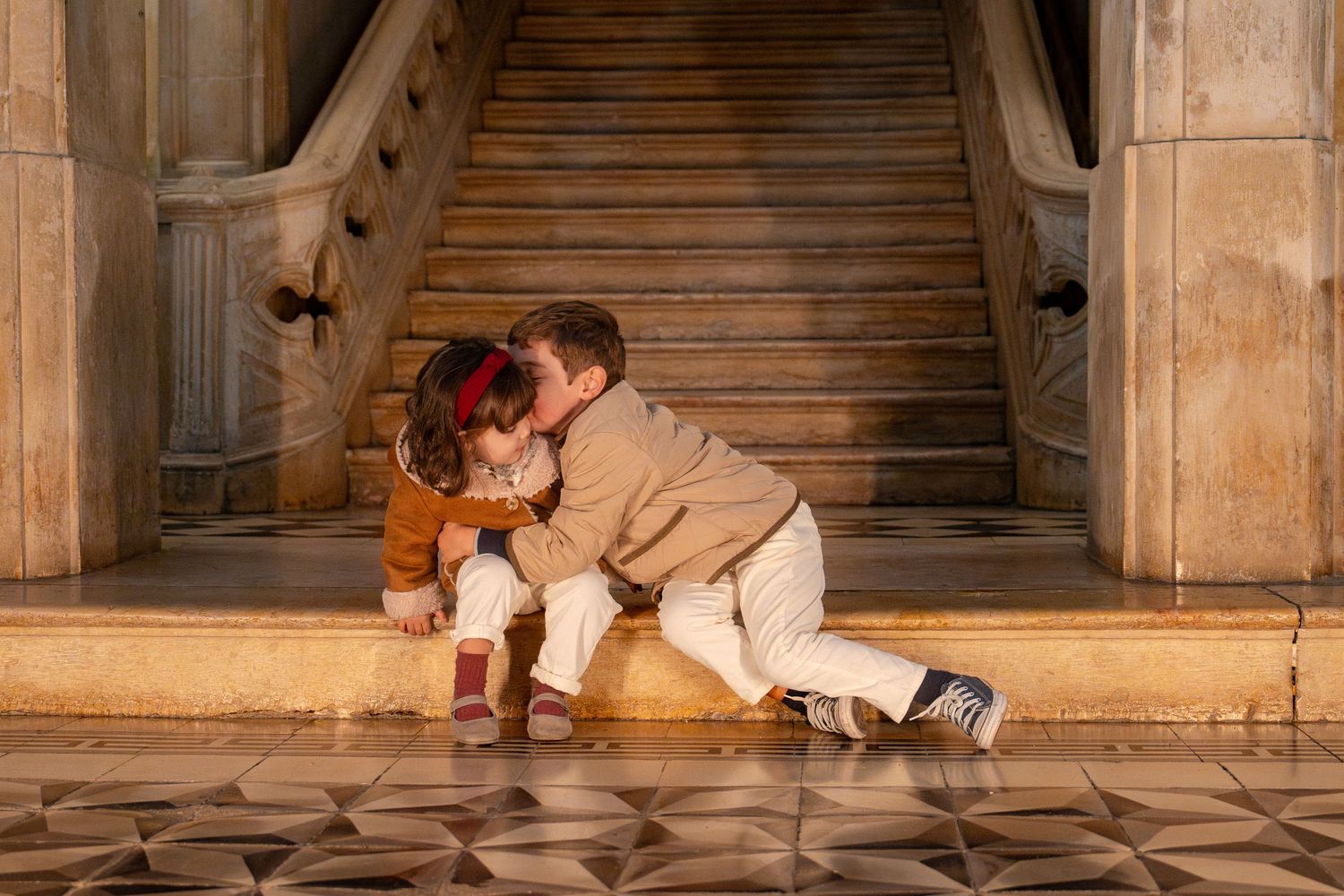 A grand stone staircase in an elegant building with warm lighting.