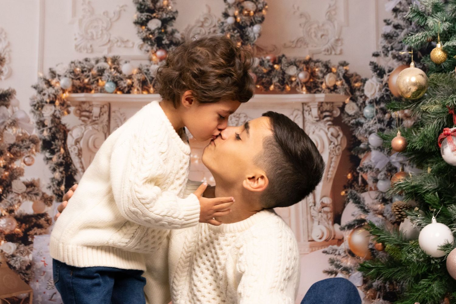 A warm holiday portrait against a backdrop of Christmas decorations and ornaments.