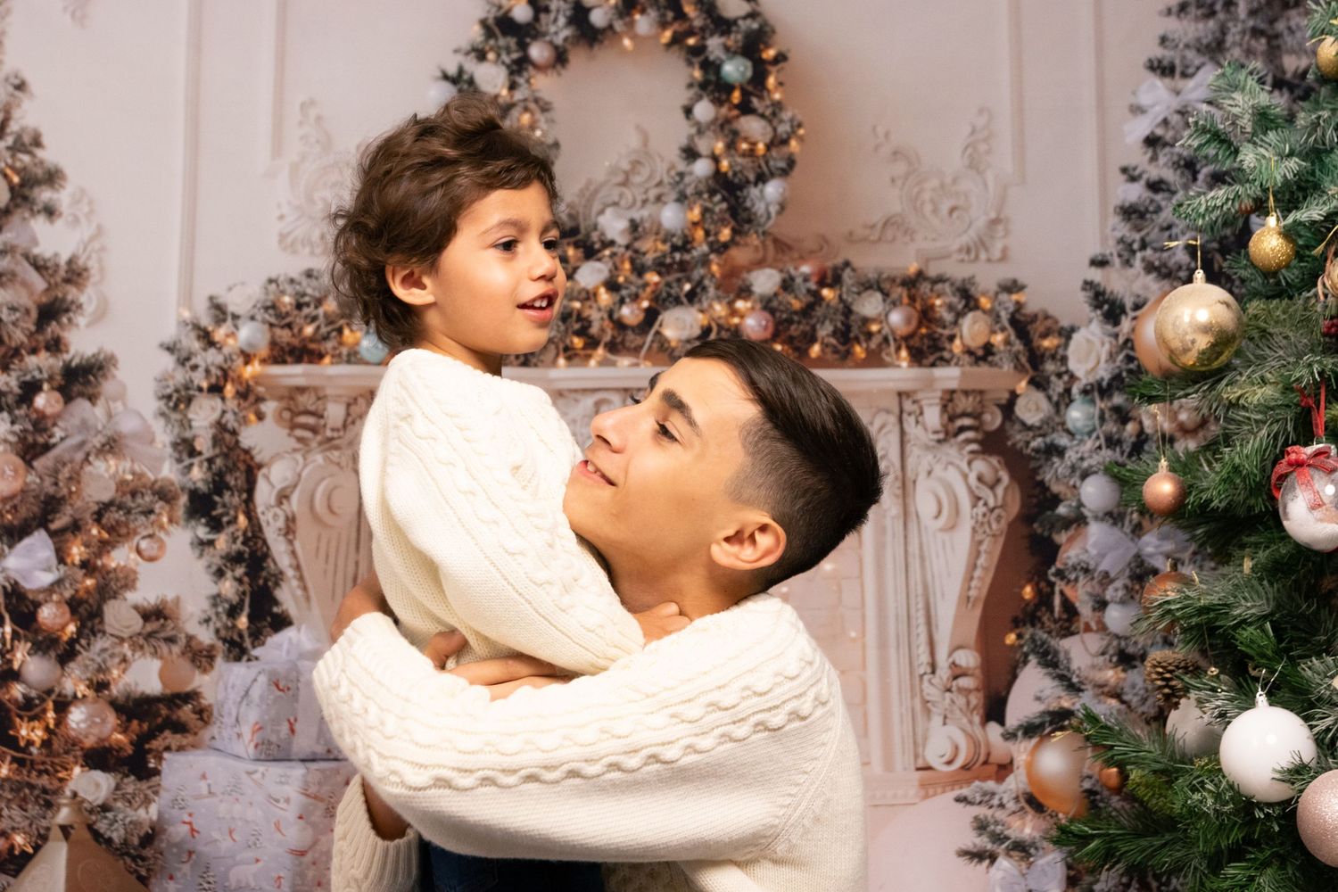 A joyful moment captured in front of a decorated Christmas tree and holiday garland.