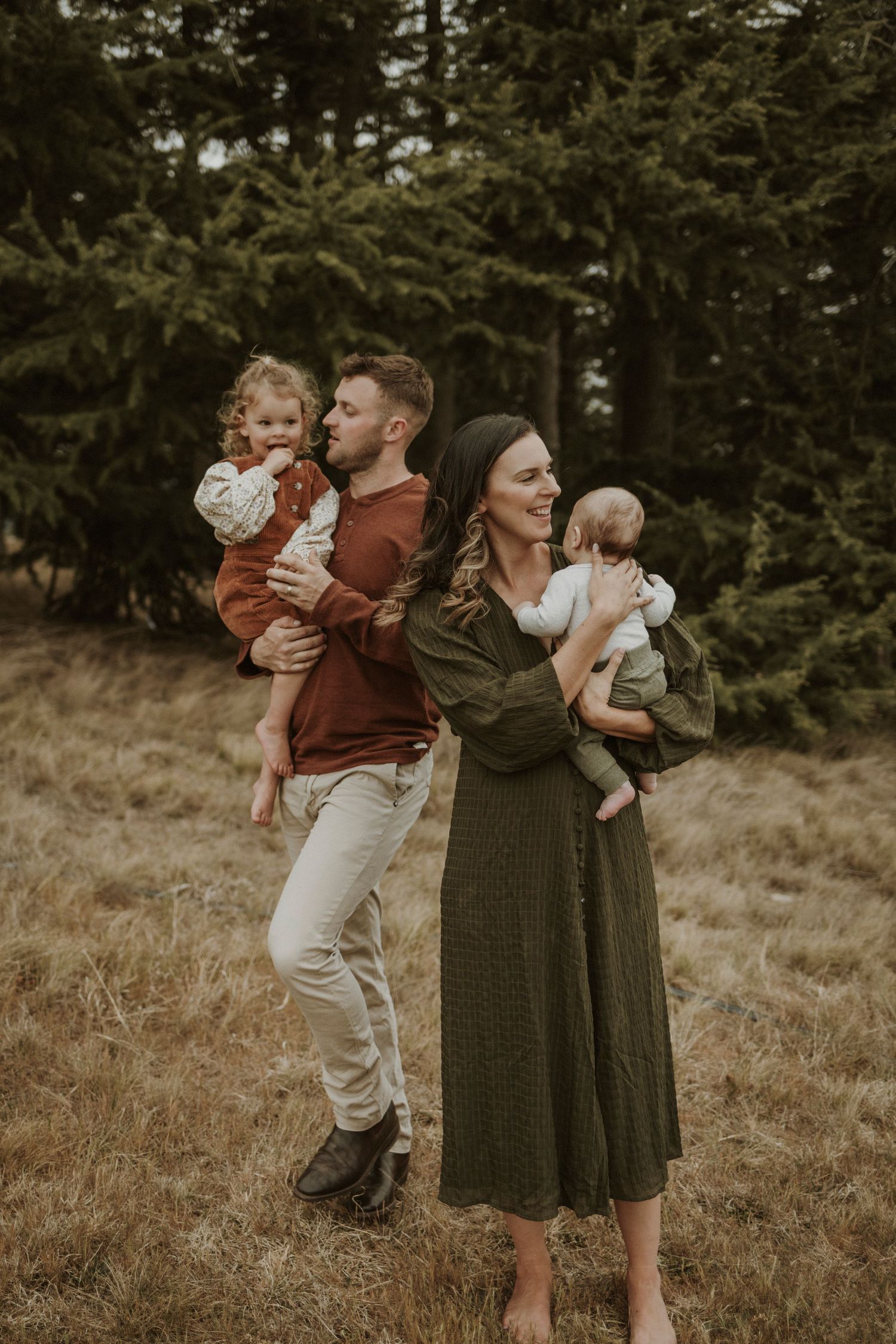 Family standing together outside cuddling and laughing
