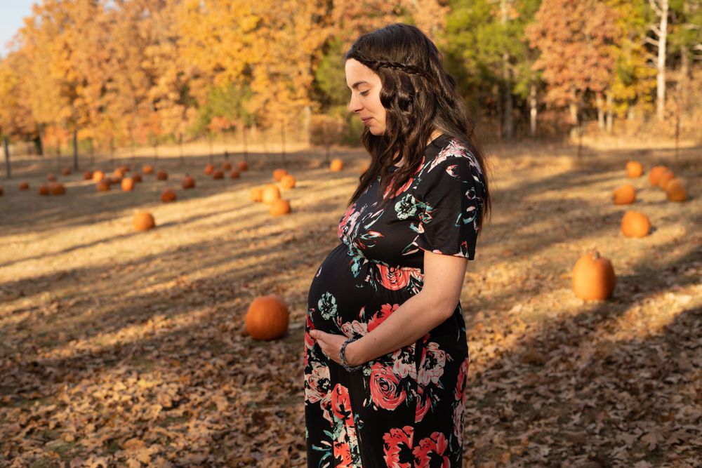 An expectant mother cradling her belly