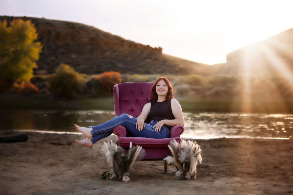 Purple armchair outdoor portrait session with two dogs at sunset.