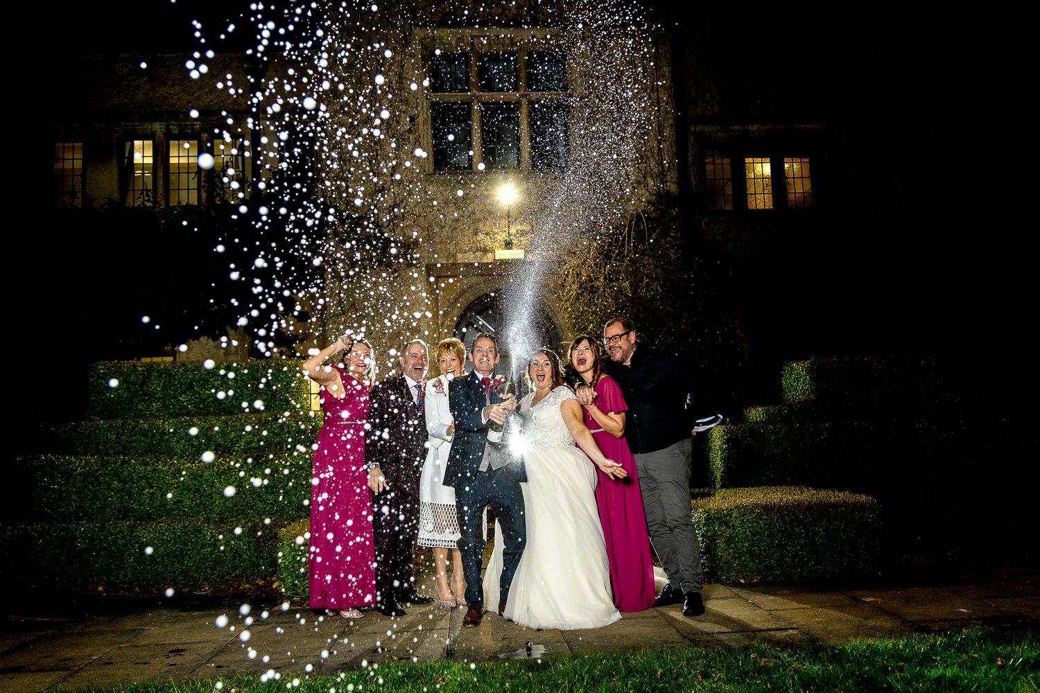 spraying prosecco bride and groom at Quorn Grange wedding photography leicestershire