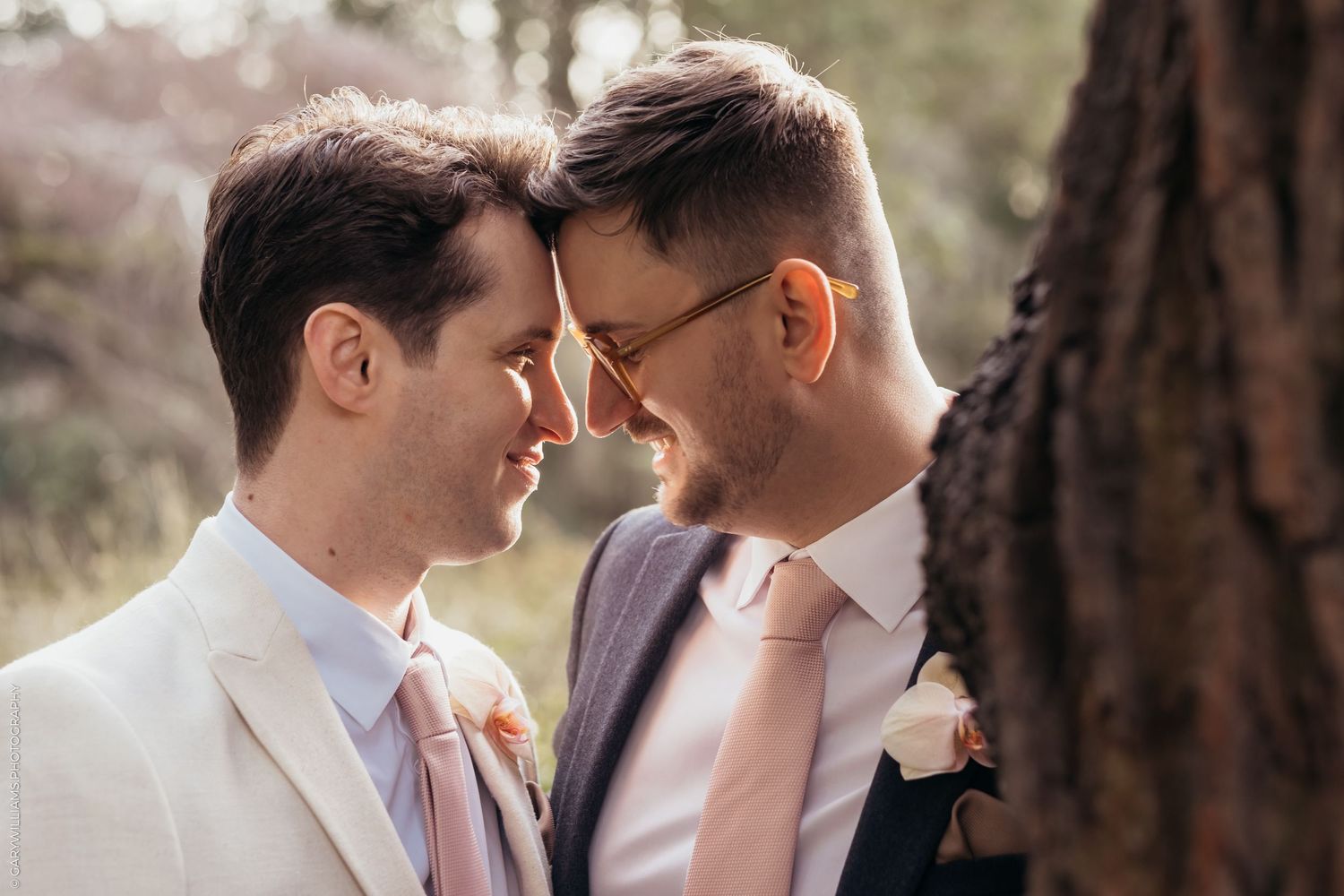 Newlywed grooms looking into each other's eyes at their gay wedding in Twickenham London