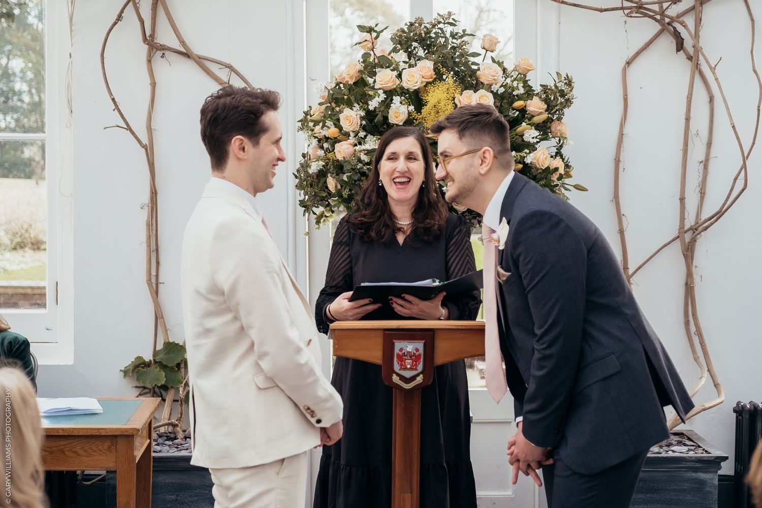Newlywed grooms laughing together at their gay wedding in Twickenham London