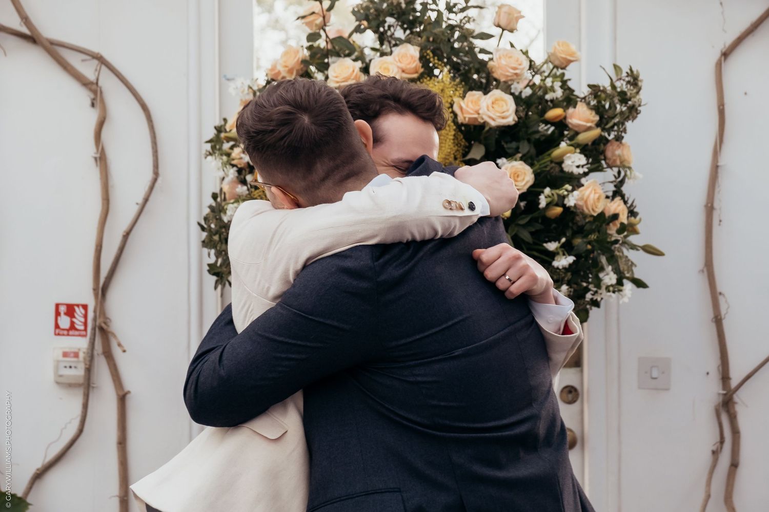 Newlywed grooms hugging at their gay wedding in Twickenham London