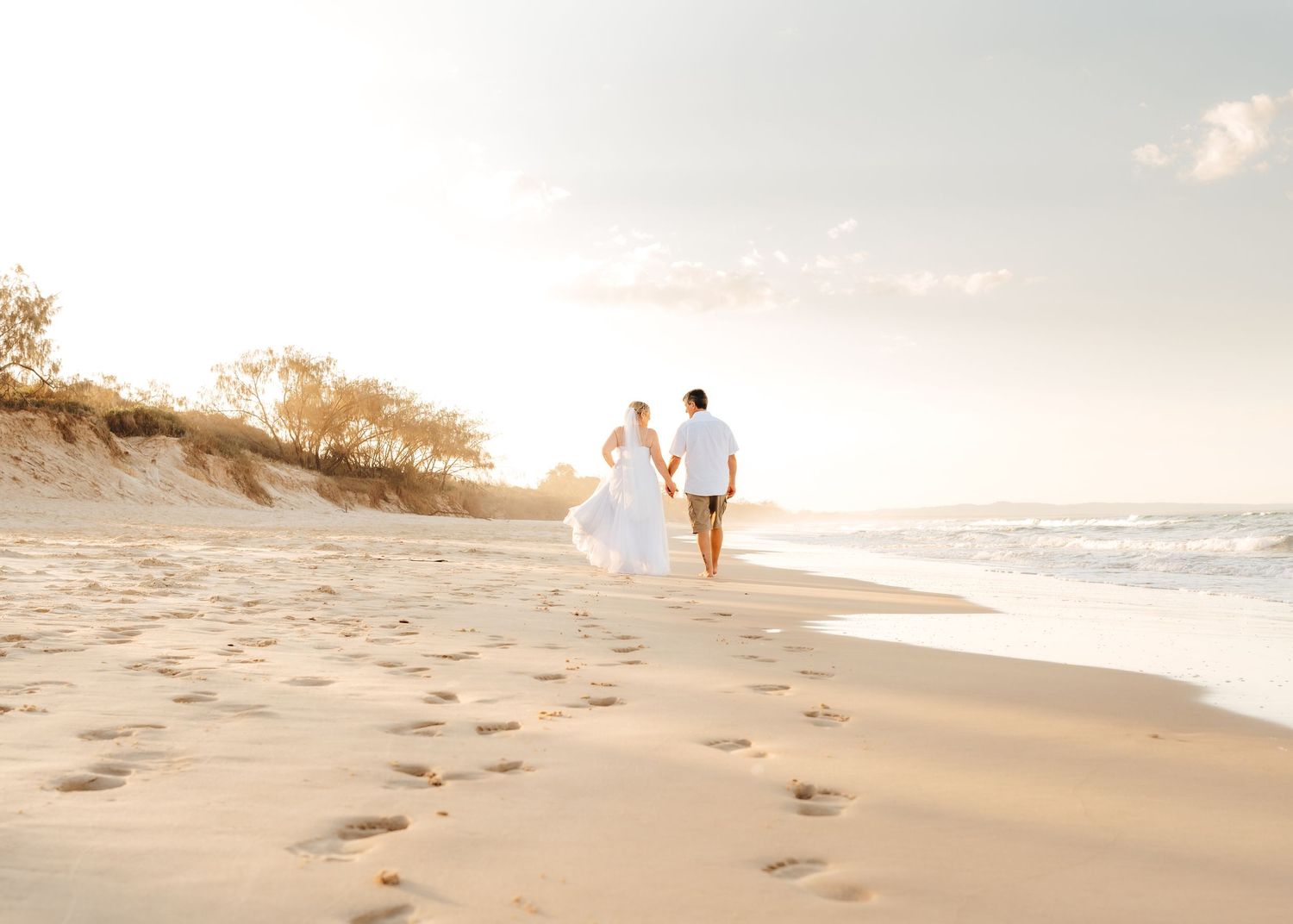 A beautiful moment from this wedding at Rainbow Beach, Queensland with Nicole Bailey Photography