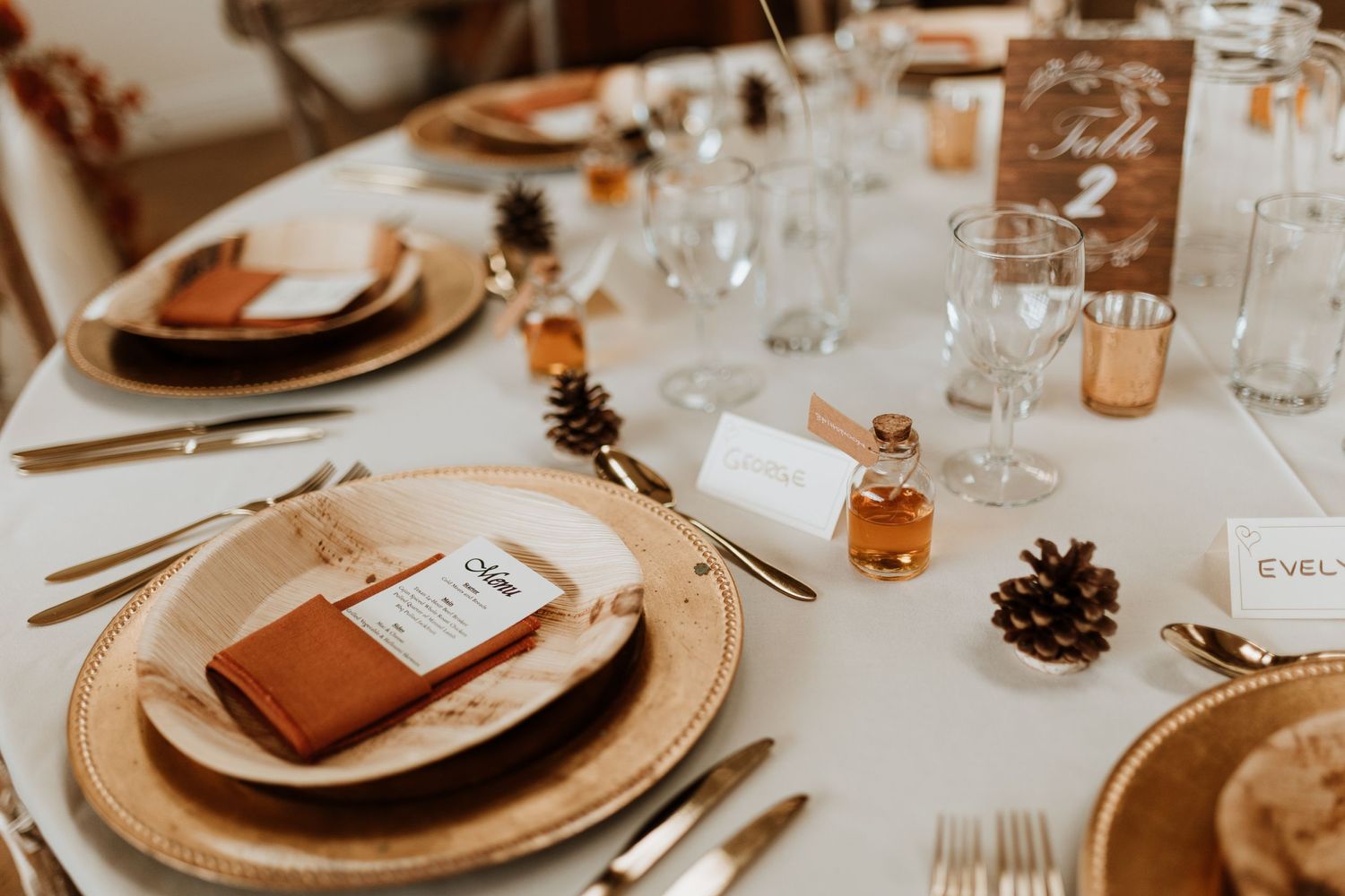 Using pine cones and home made dried fruits for table scapes for seasonal wedding