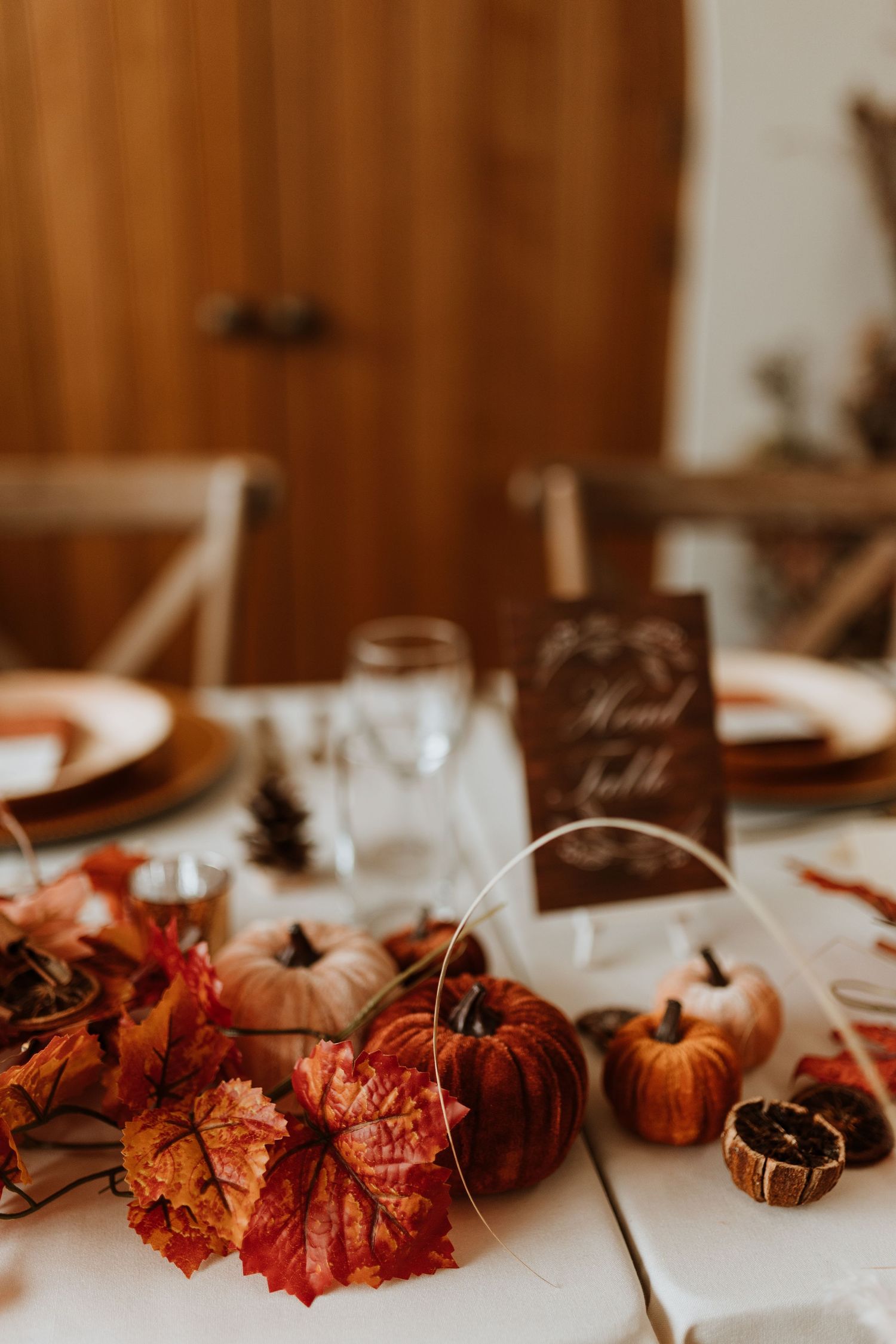 Autumn leaves and pumpkins used for wedding breakfast decor and tablescapes