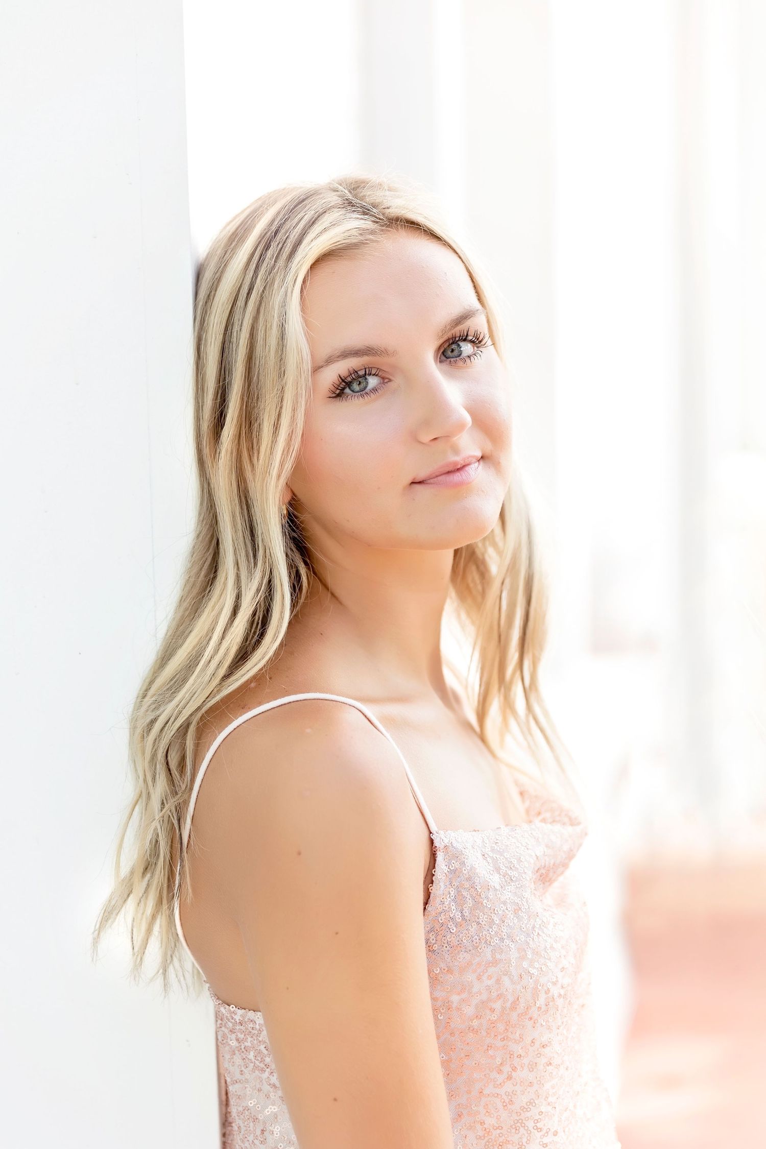 Soft, romantic portrait session in a bright studio with delicate lighting.