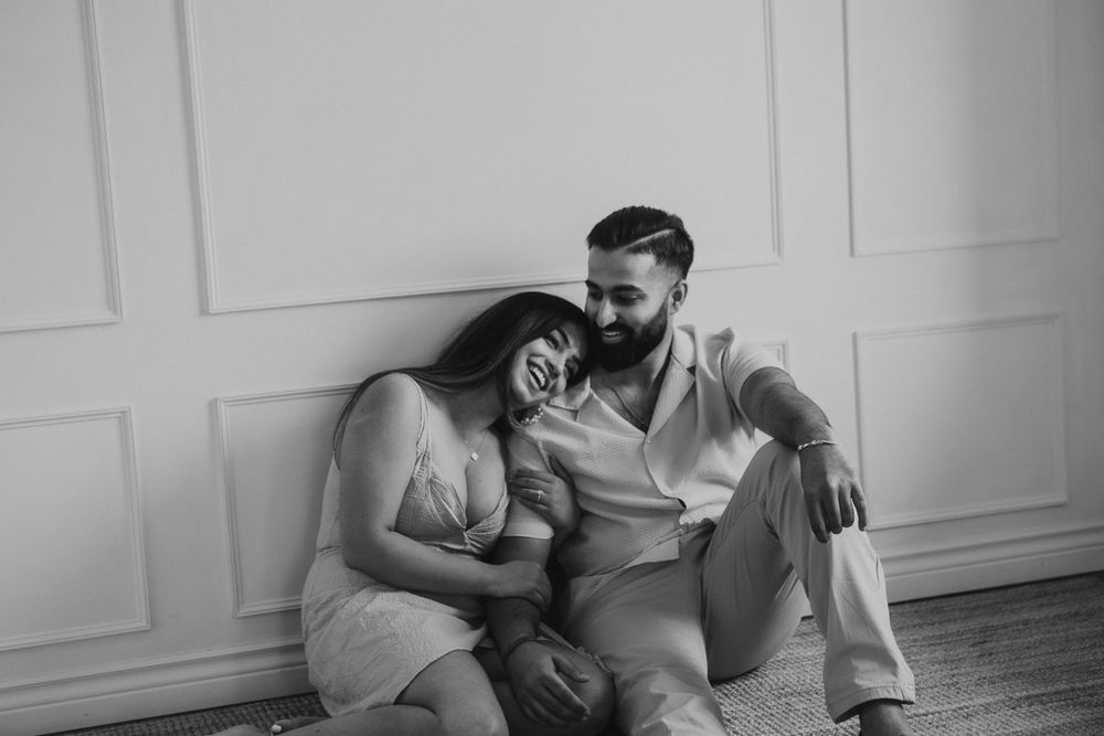 Intimate black and white photo session capturing tender moments on a light background.
