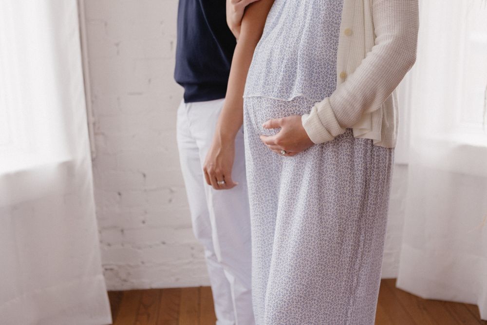 People in casual white and navy outfits interacting in a bright indoor setting.