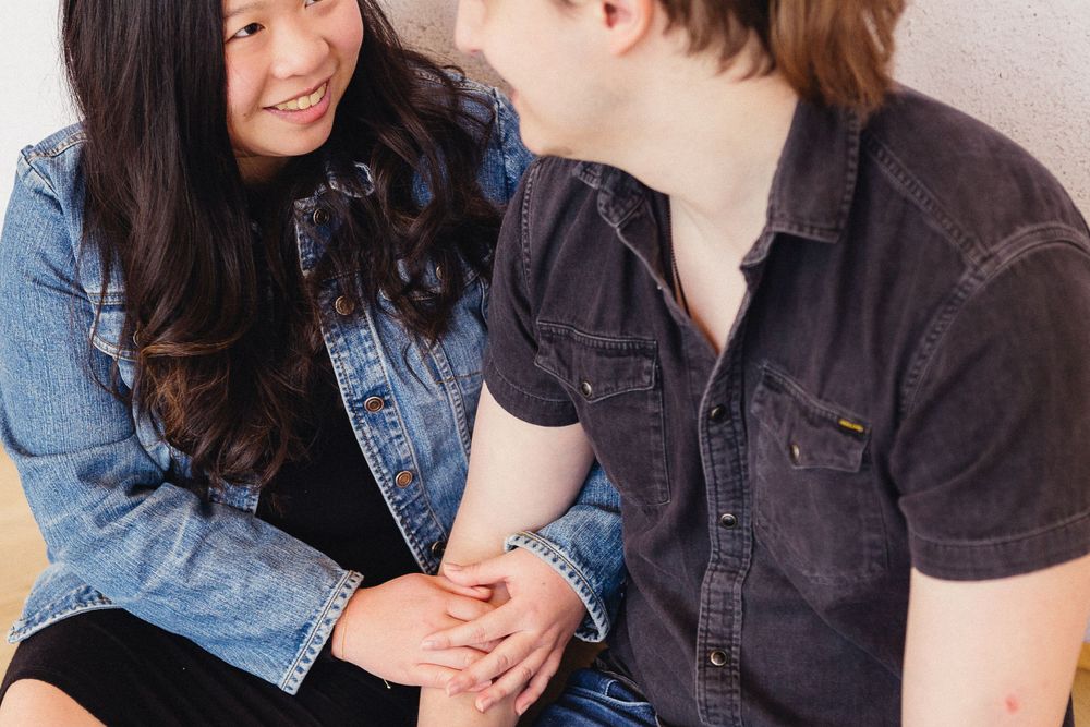 A couple in denim and dark clothing sharing intimate moments in a photo series.