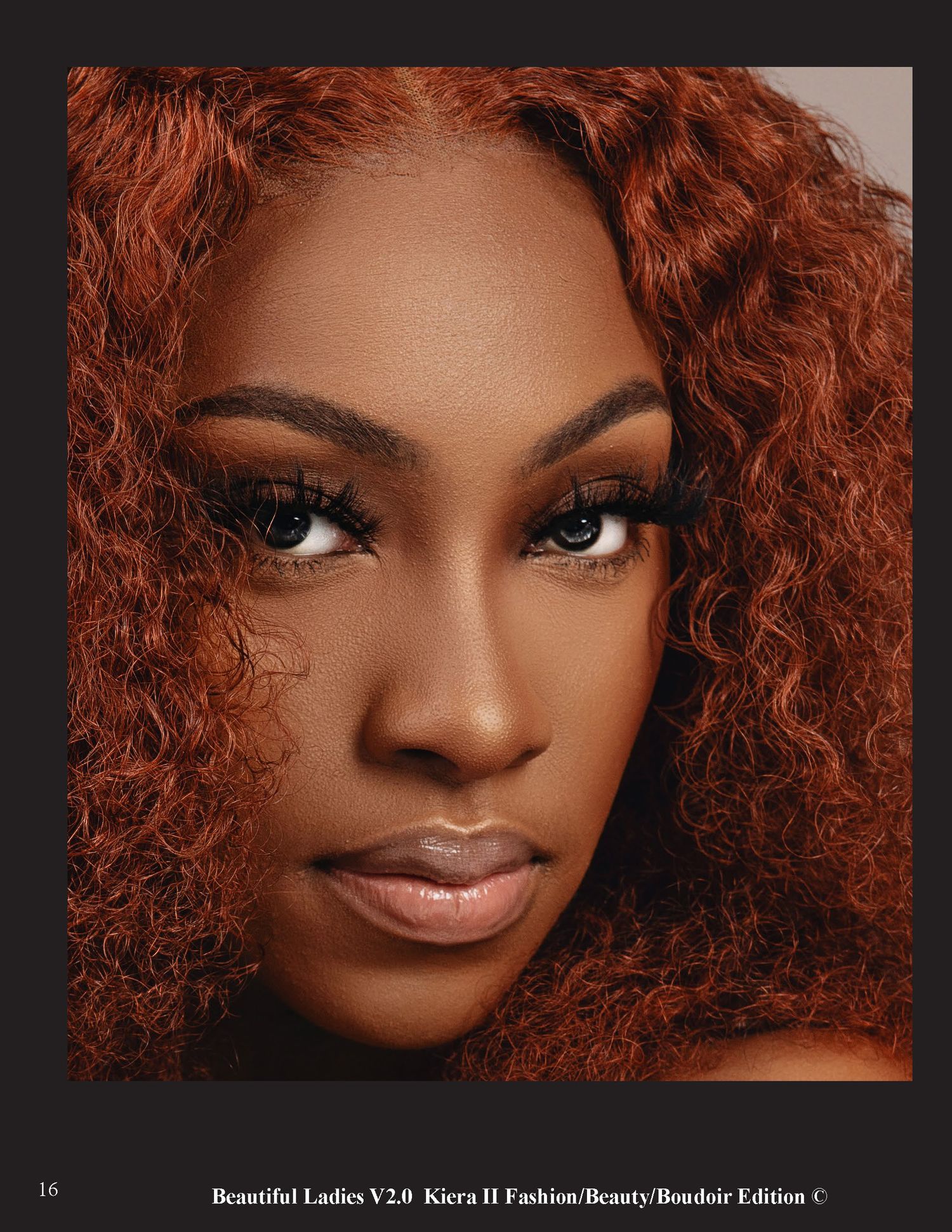 Beauty closeup featuring auburn curly hair, flawless makeup and warm lighting against dark background.