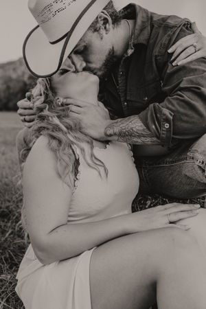Black and white portrait of romantic couple sharing tender moment outdoors.
