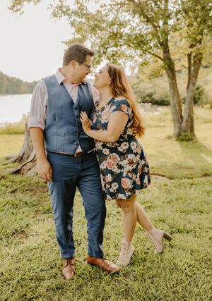 Romantic couple in coordinated outfits sharing intimate moment outdoors.