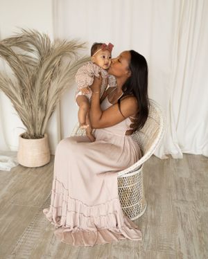 Family photoshoot with pampas grass decor and soft pink ruffle dress details.