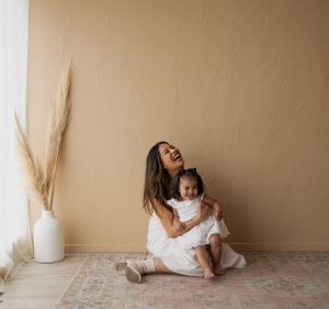 Lifestyle family photos with minimalist decor featuring pampas grass and neutral tones.