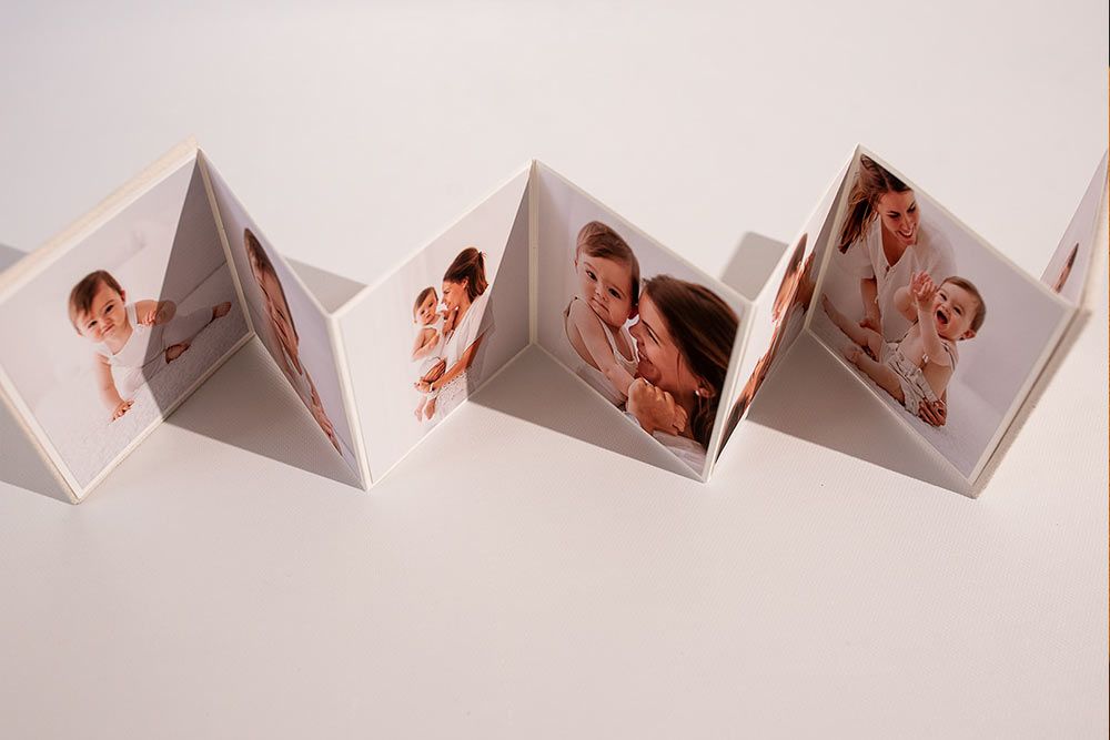 Accordion-style photo display showing vintage family photographs.