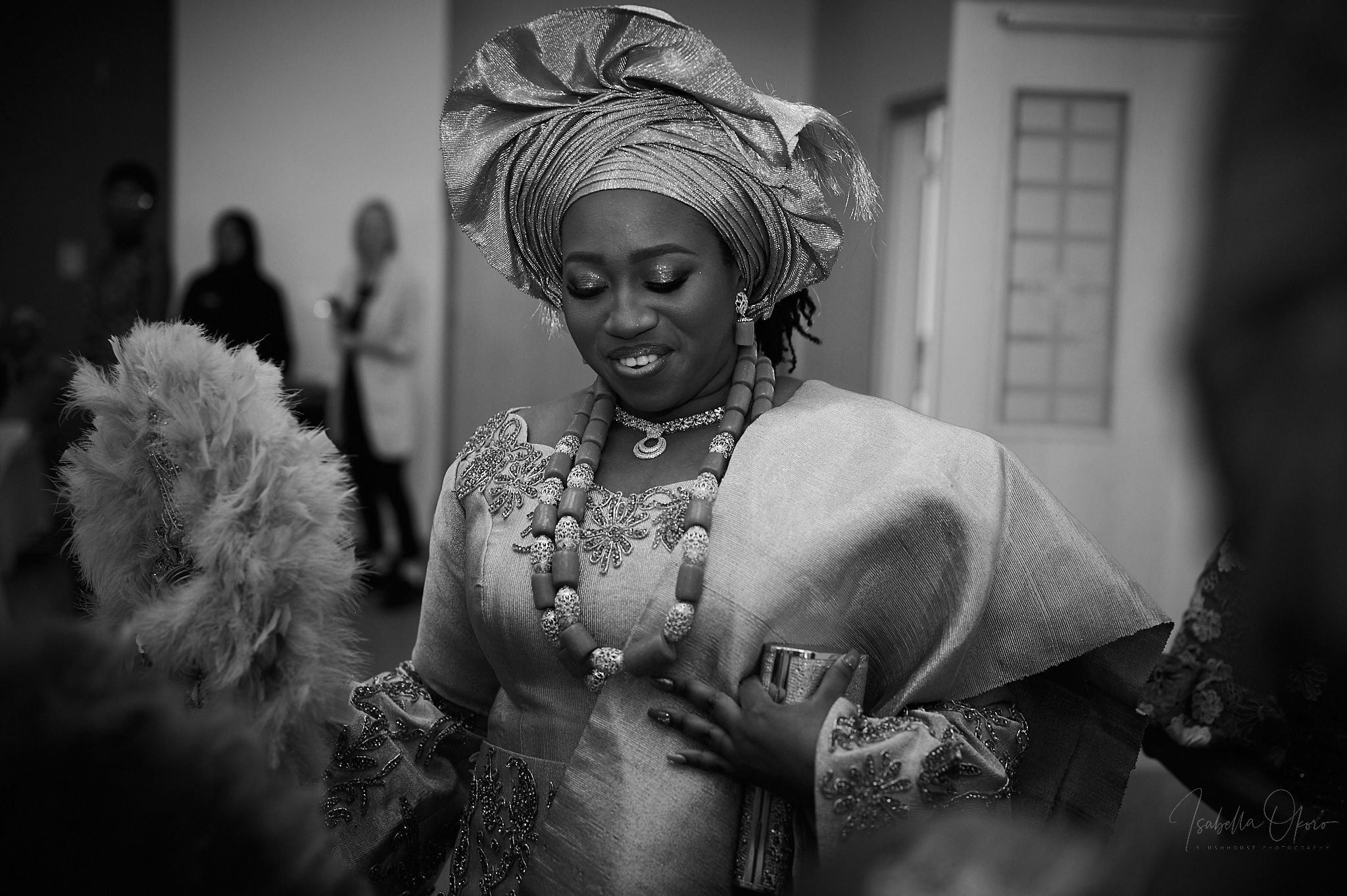 Traditional Nigerian wedding attire and jewelry captured in black and white.