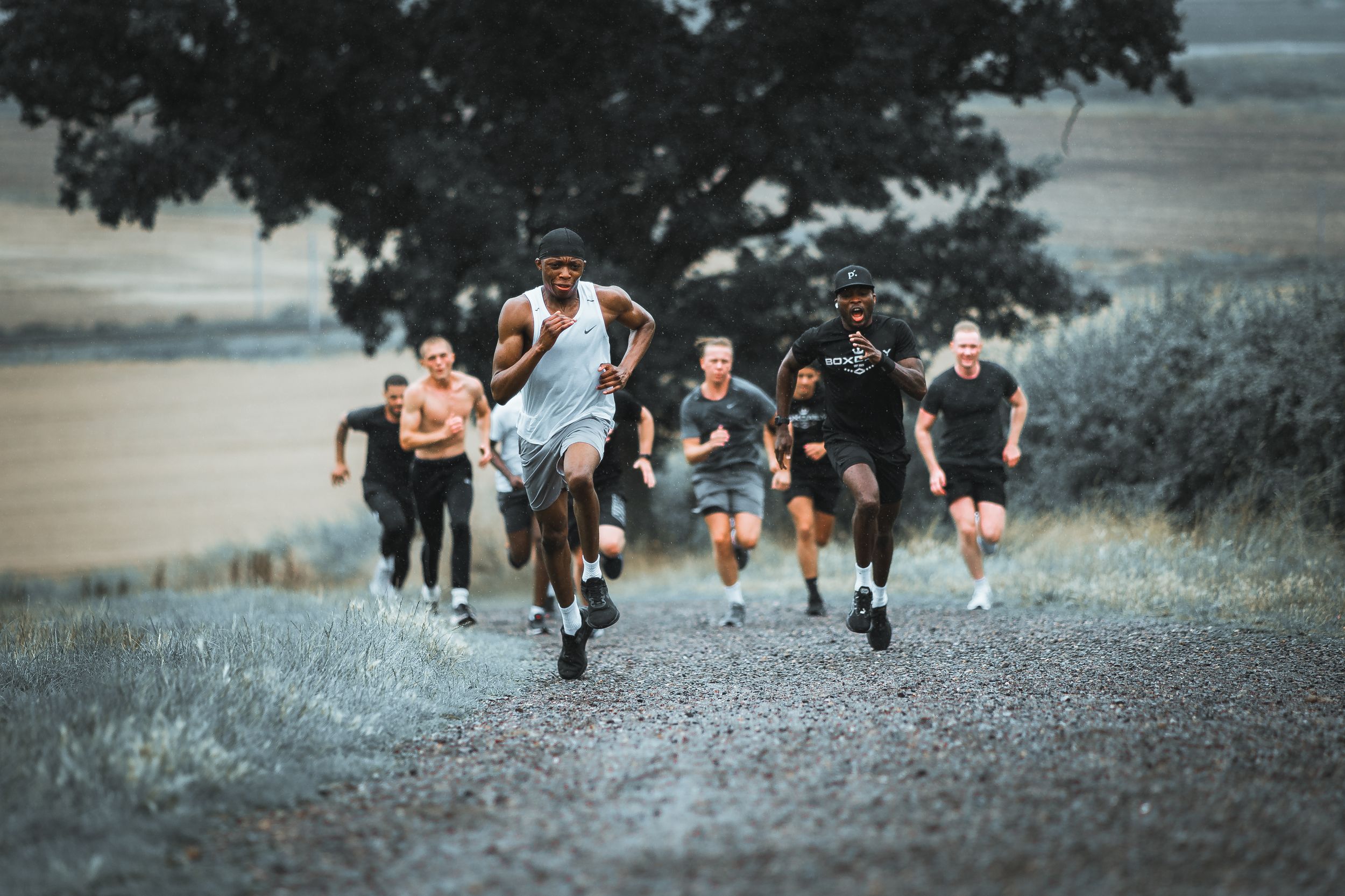Low angle view of runners' feet moving along a gravel path during outdoor exercise.