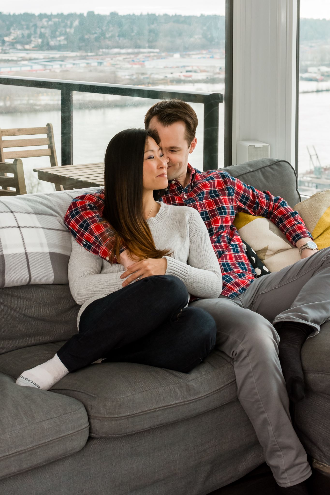 couple snuggling on a couch, couple cuddling up, indoor couples photo session, New Westminster, BC