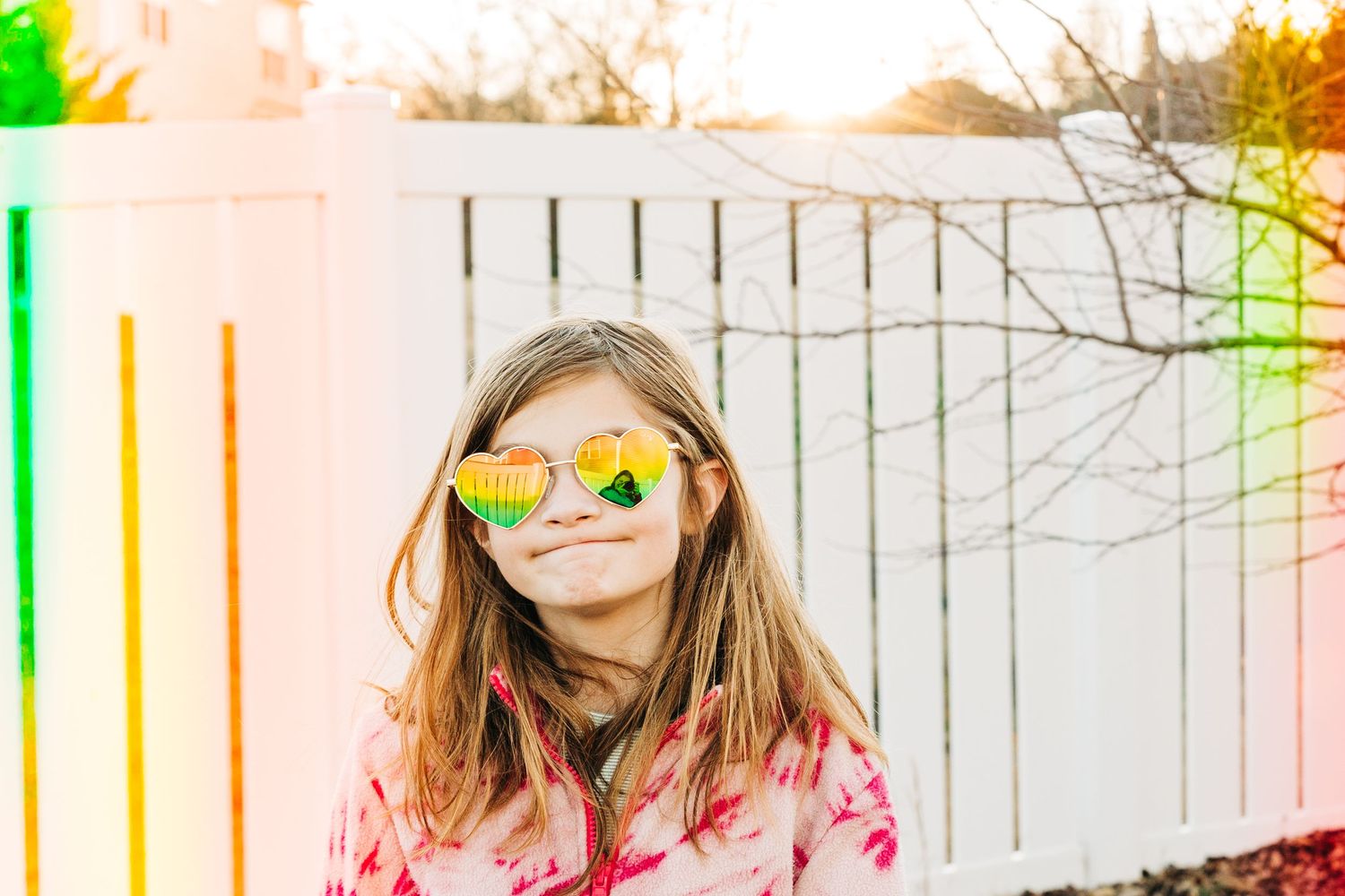 young girl with heart sunglasses and rainbow around her in Charlotte