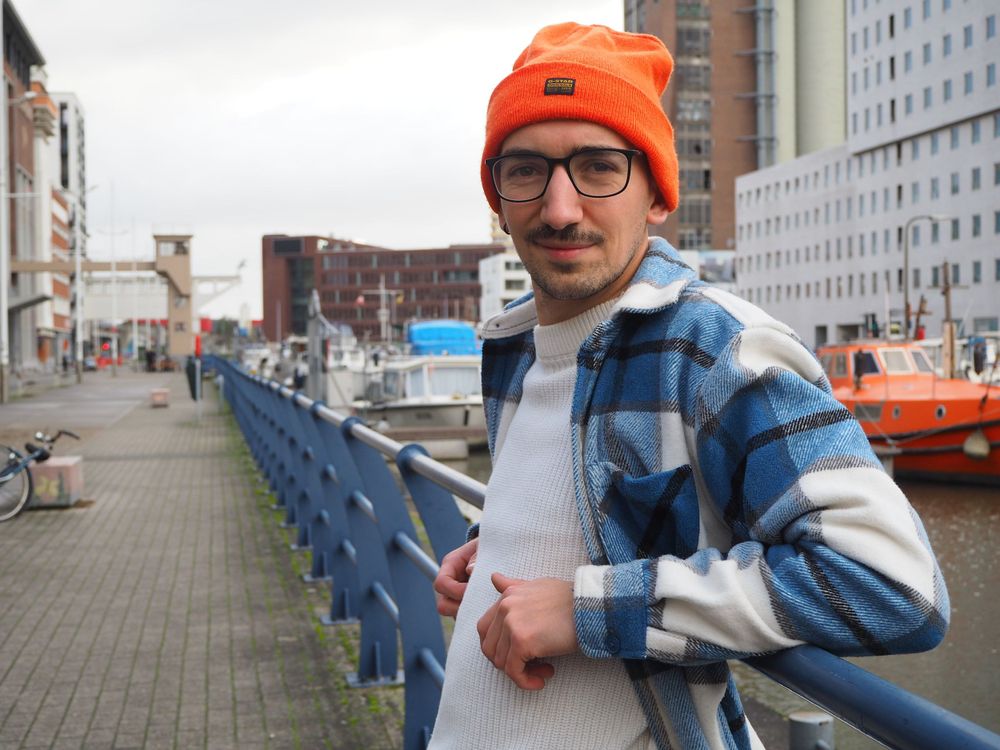 Portrait of a guy wearing an orange beanie