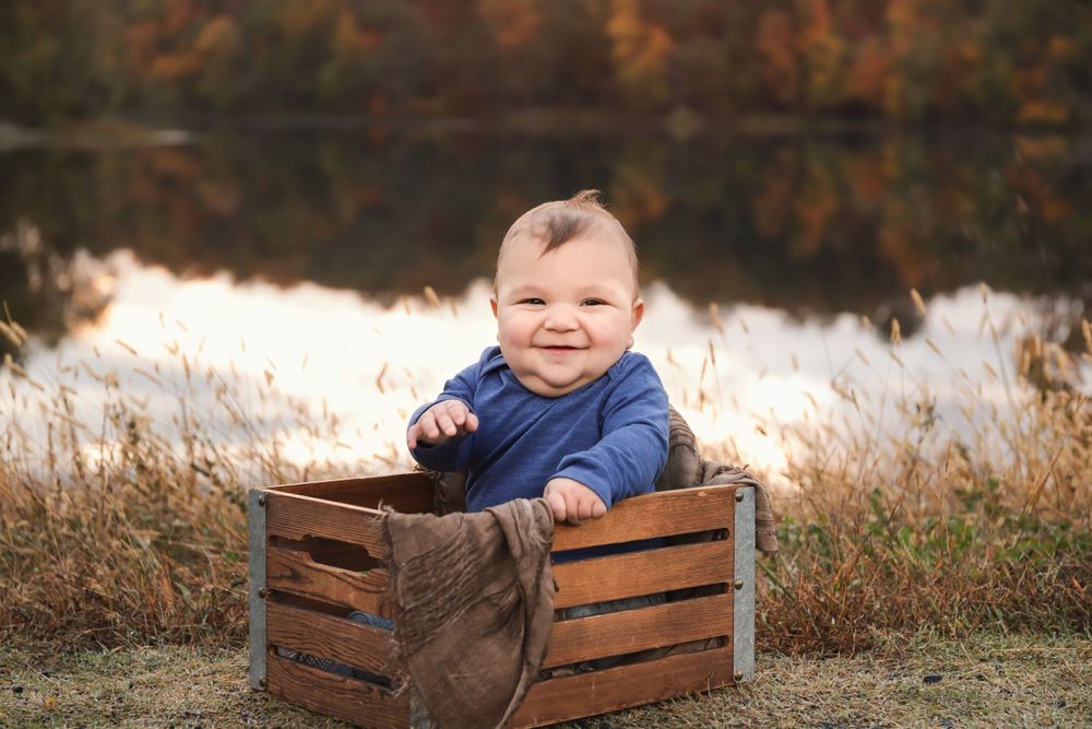 fine art milestone fall portrait of baby boy with fall leaves in harford county, maryland
