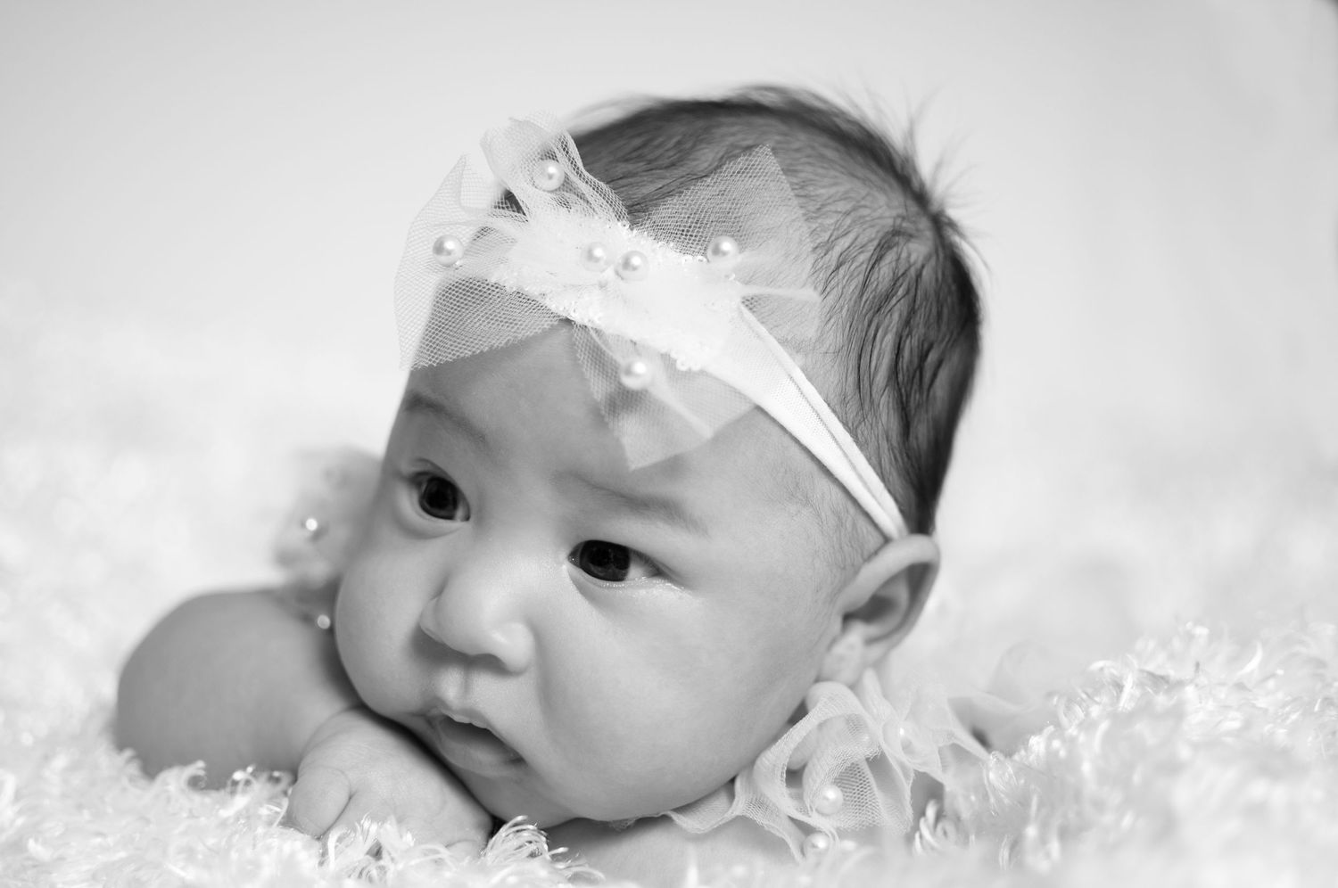 Newborn girl closeup in black and white