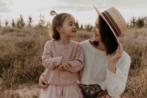 A heartwarming family photoshoot in a field during golden hour.