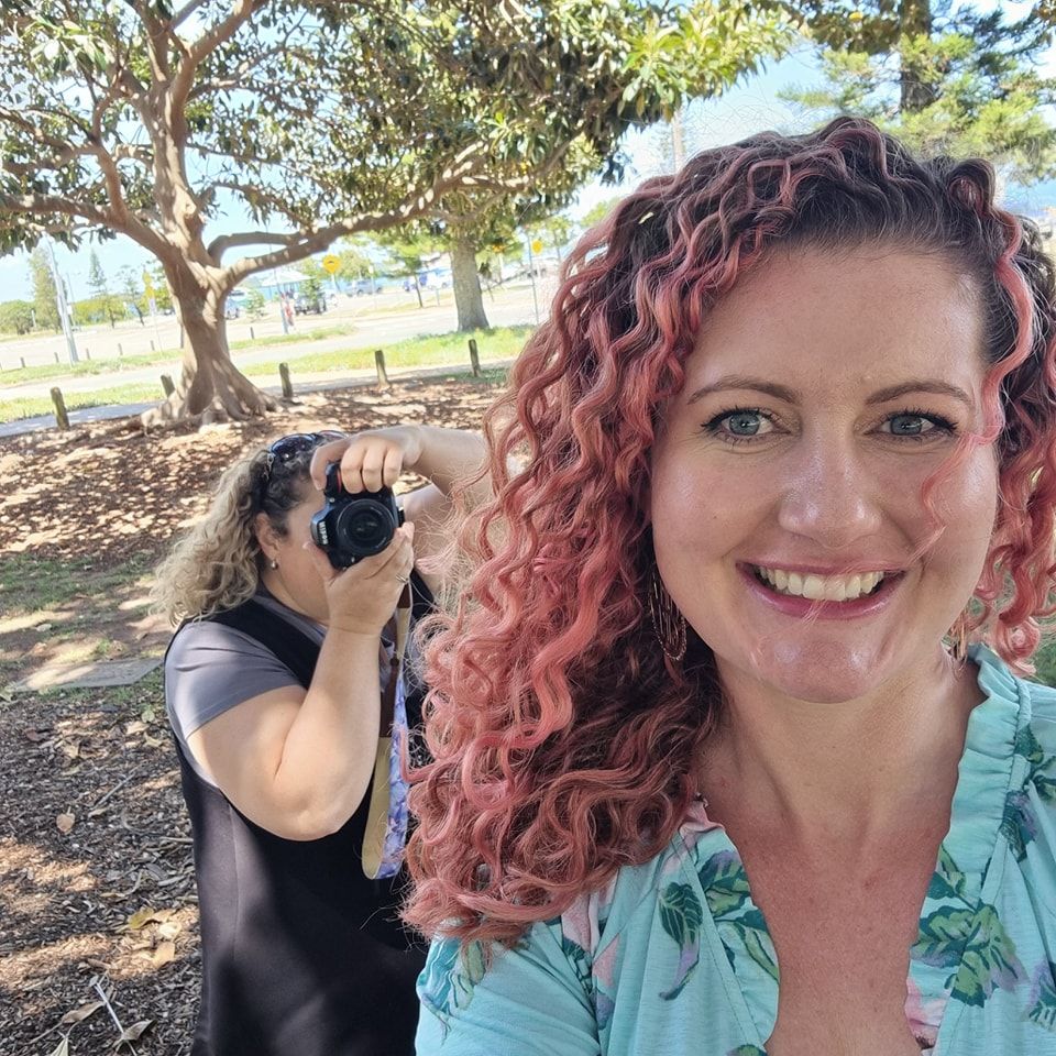 Behind the scenes shot of photographers working outdoors under trees.