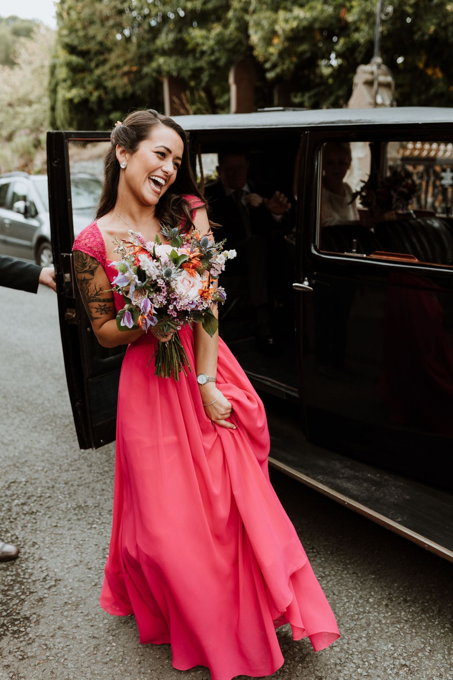 bright pink bridesmaids dress and poppin florals