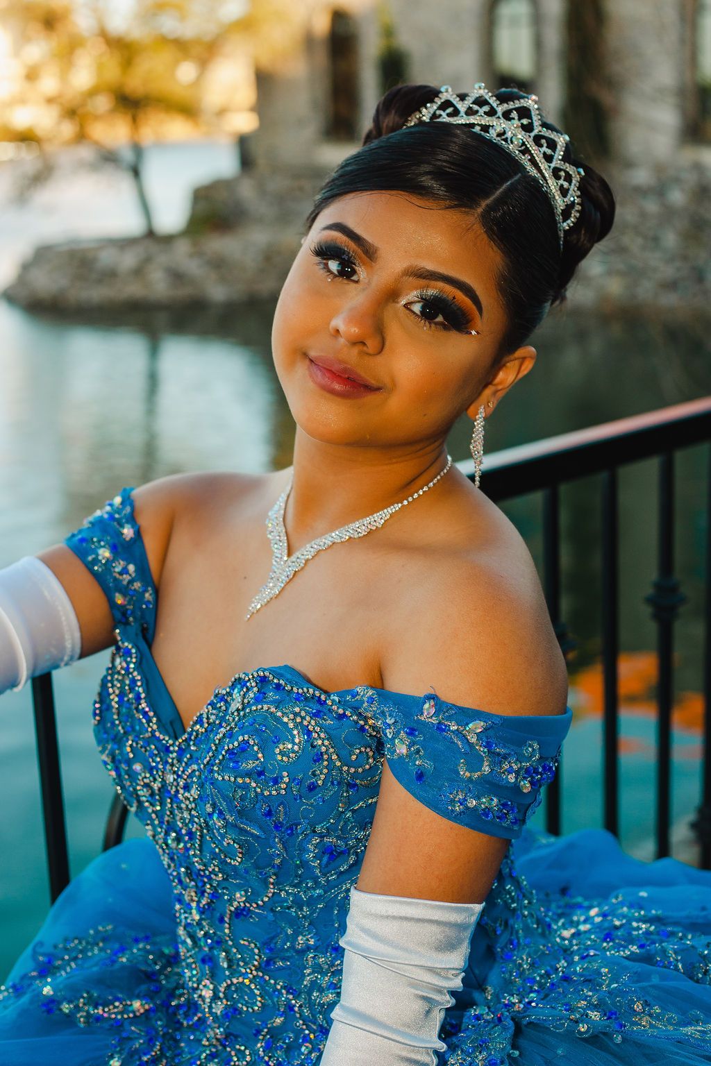 Elegant blue formal gown with crystal embellishments and off-shoulder design.