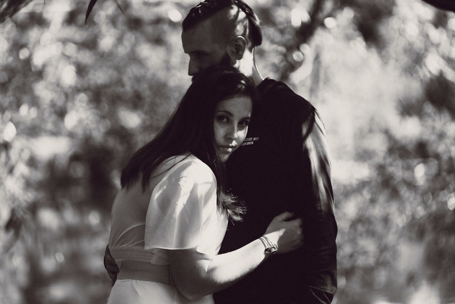 Couple hugging during engagement photo shoot a Liverpool Festival Gardens