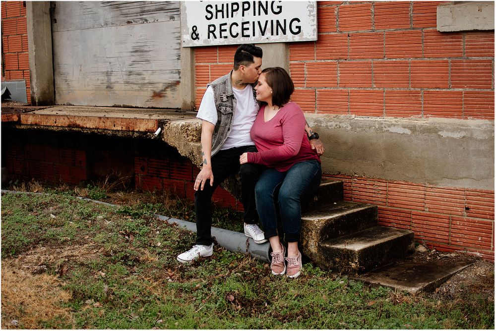 Casual outdoor portrait session on concrete steps with shipping sign visible.