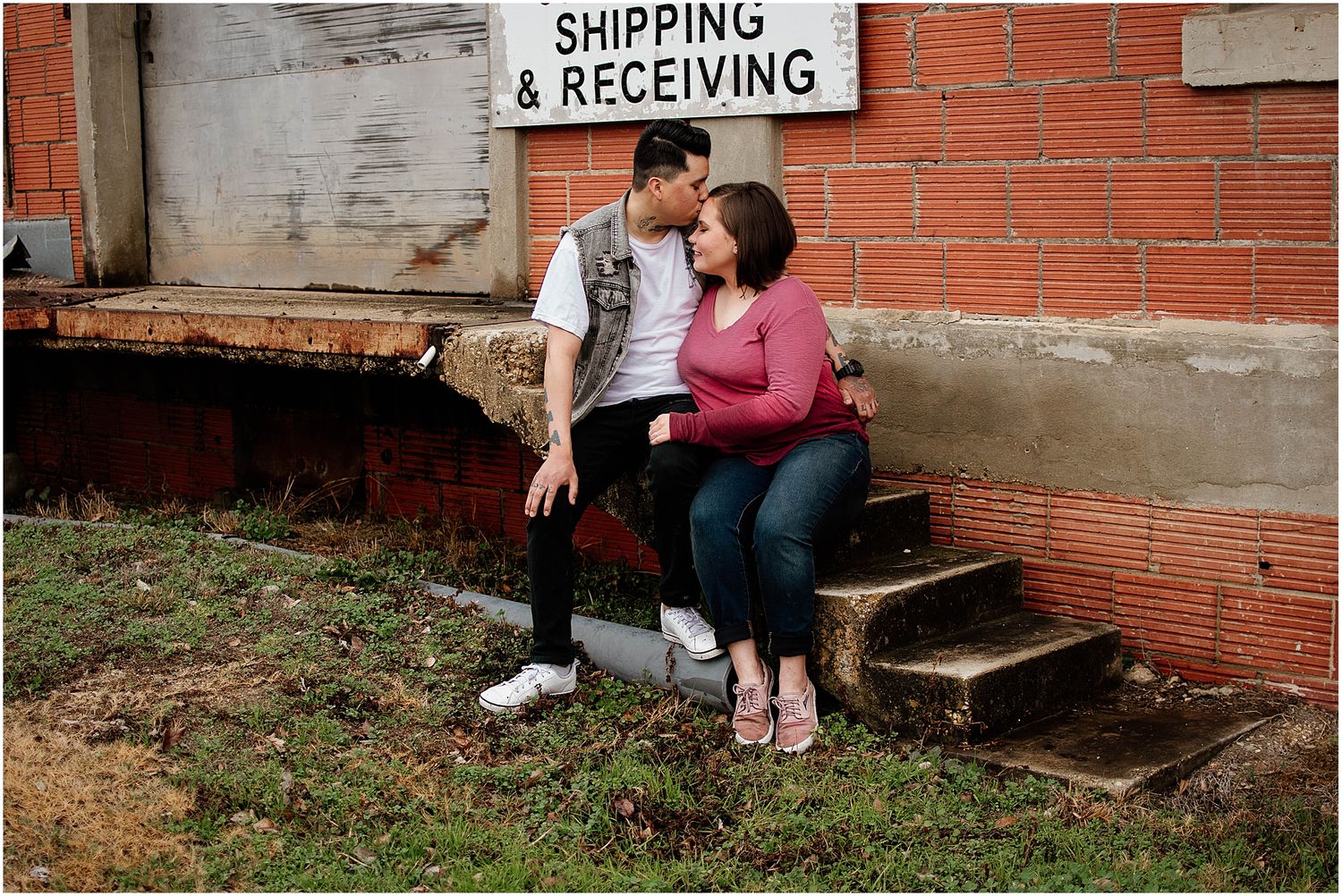Casual outdoor portrait session on concrete steps with shipping sign visible.