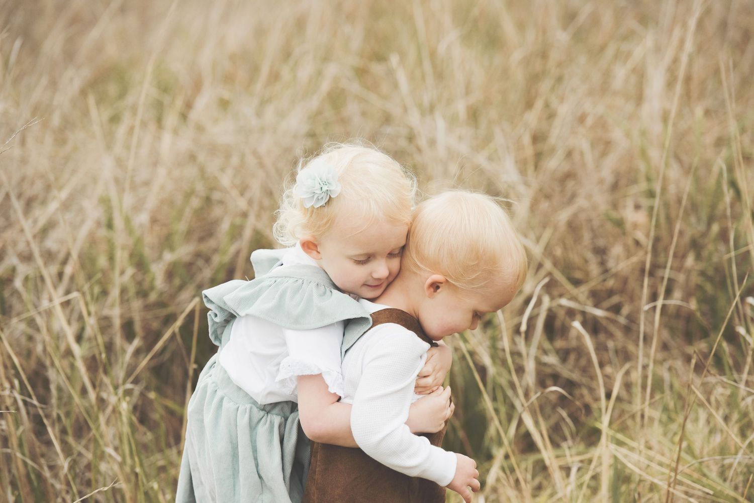 Brother and sister session in a grassy field