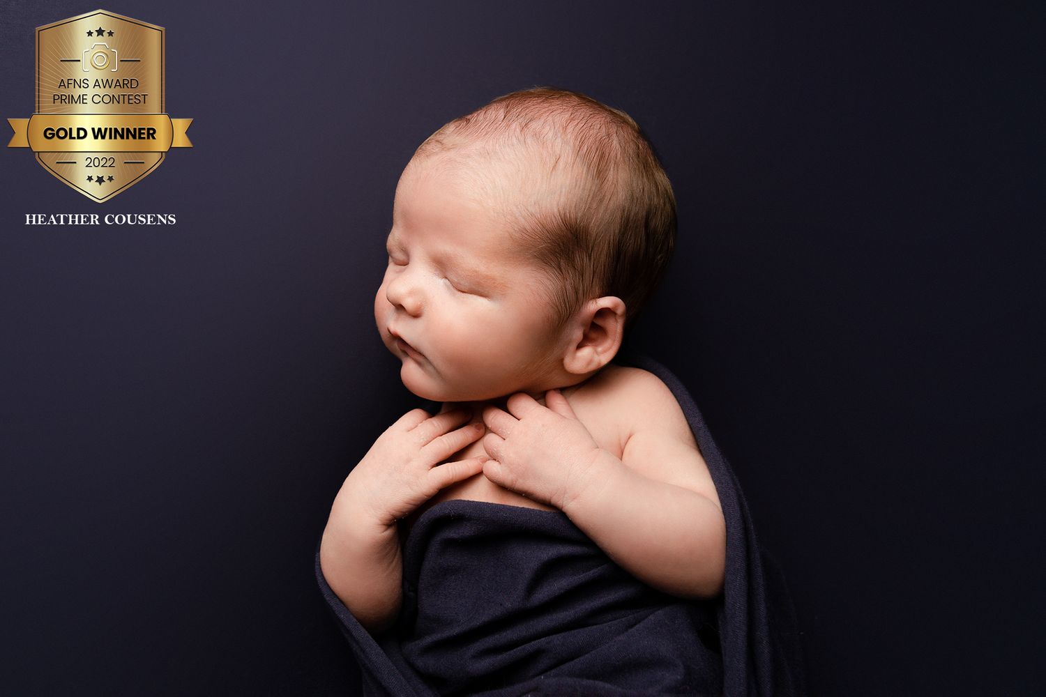Baby boy fast asleep on a blue blanket, tucked in by newborn photographer in Doncaster