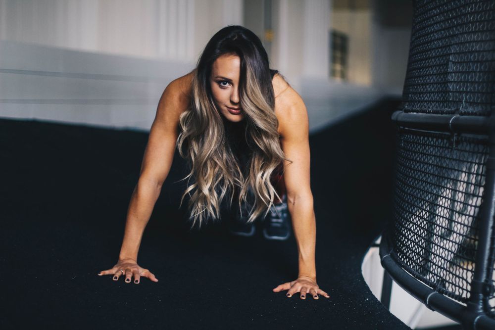 Athletic poses captured against dark background in contemporary fitness studio.