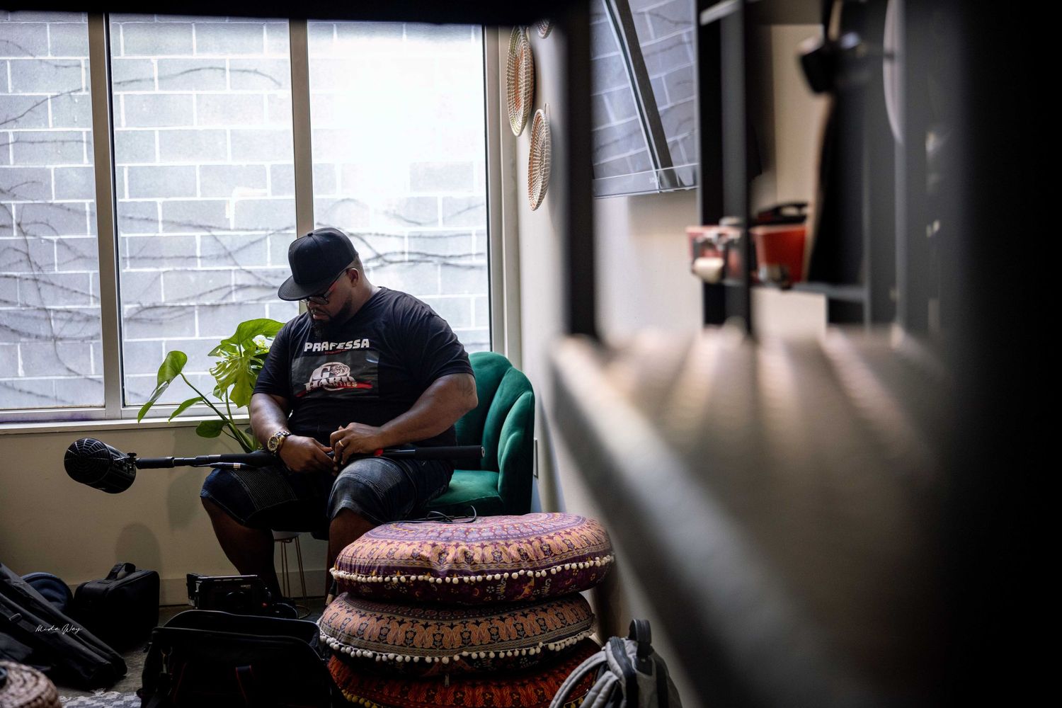 Silhouette of someone working at a desk near a window with natural light.