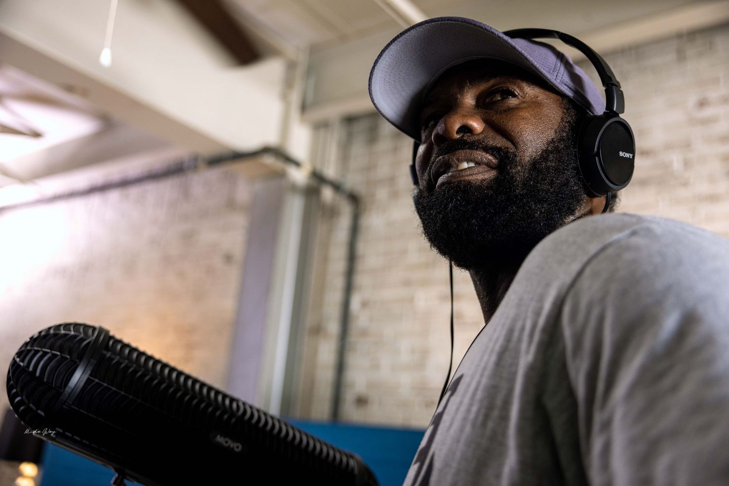 Audio technician smiling while wearing headphones during production.