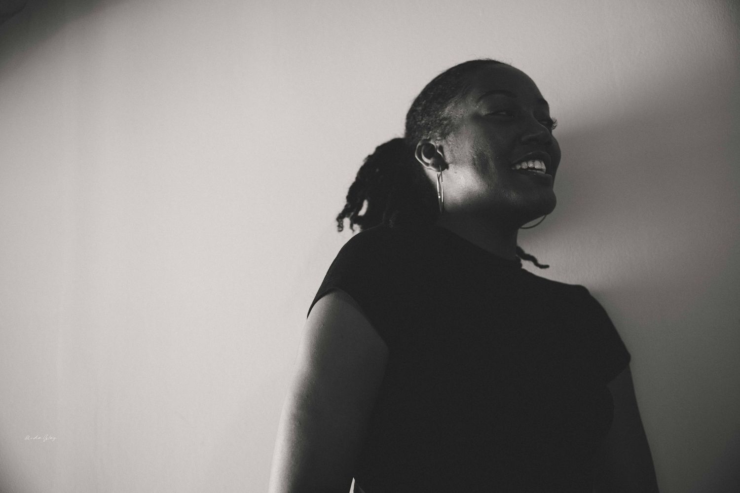 A silhouetted profile view against a light background in black and white.