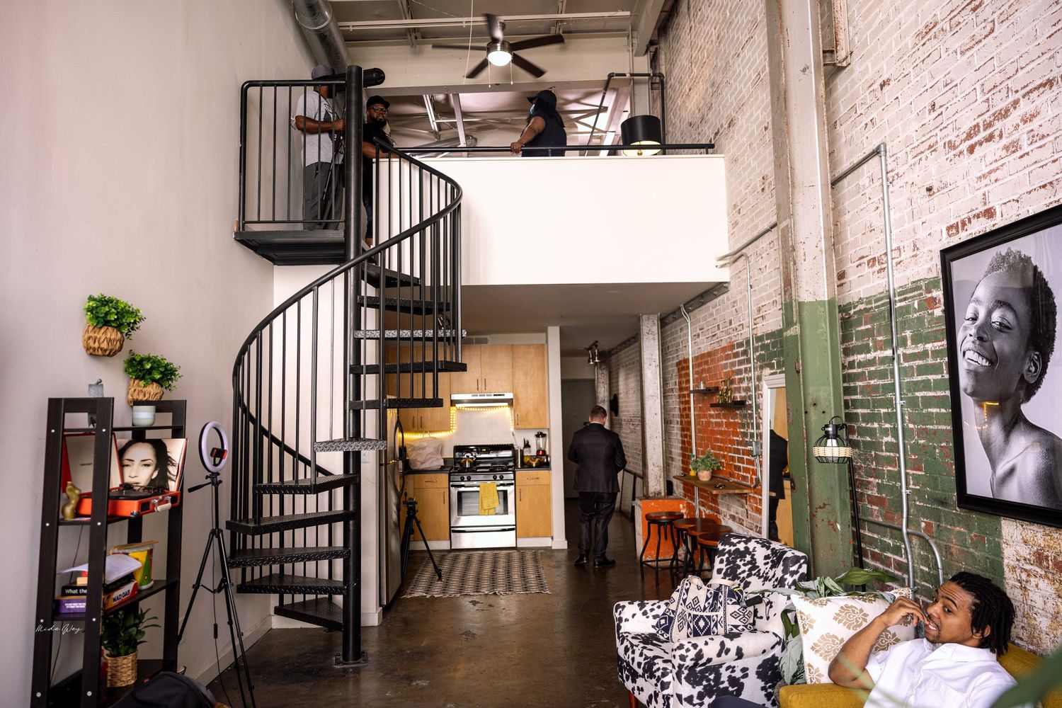 Modern loft apartment interior with white walls and exposed brick features.