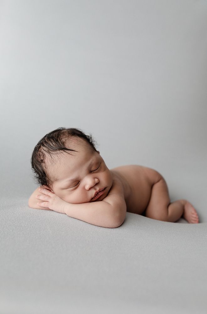 Eden Prairie newborn photographer | baby-laying-facing-forward-on-light-blue-blanket